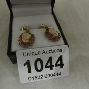A pair of 9ct gold earrings set cameos