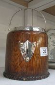An oak biscuit barrel with blue willow pattern liner