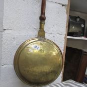 A brass warming pan