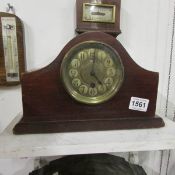 A small wooden mantel clock