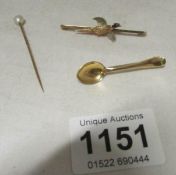 A 9ct bar brooch with pheasant, a yellow metal spoon brooch and a stick pin