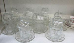 A quantity of Pyrex cups and saucers