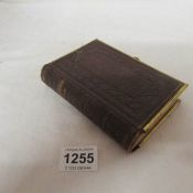 A small brass bound Bible with coloured illustrations