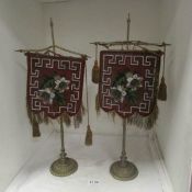 A pair of Victorian beaded face screens on brass stands