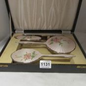 A cased silver and enamel vanity set
