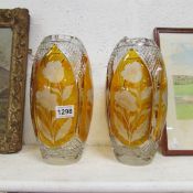 A pair of gold coloured lead crystal vases with floral etching