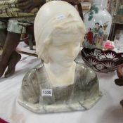 A marble bust of a young woman