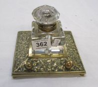 A brass and glass inkwell