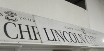 2 very large 'Lincoln Chronicle' sign