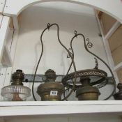 A quantity of oil lamp fonts and hanging oil lamp frames