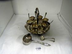 A egg cruet (missing 1 spoon) a strainer spoon and ladle