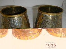 A pair of Islamic brass pots