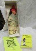 A hand made doll of Nahkom and a signed book