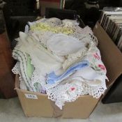 A box of linen doilies etc