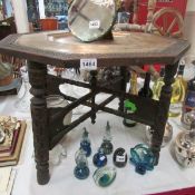 A carved wood Indian table with brass tray inset