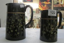 2 graduated black pottery jugs