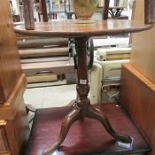 An oak tripod table with old repair to leg