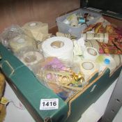 A box of rolls of fabric and ribbons