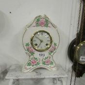 A china floral decorated mantel clock