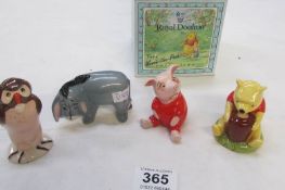 A boxed Royal Doulton Winnie the Pooh and 3 unboxed Beswick Winnie the Pooh figures