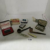A mixed lot of pipes, penknives, lighters etc