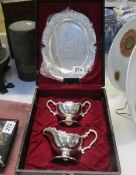 A cased silver plate jug, basin and tray