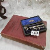 A 1931 edition Medical Dentistry book and cased dental tools