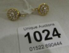 A pair of unmarked 18ct gold and diamond earrings with valuation certificate