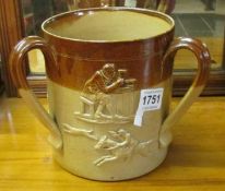 A large loving cup in the style of Doulton Lambeth, a/f