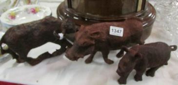 A carved wood buffalo, rhino and wild boar