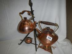 2 copper kettles on stands