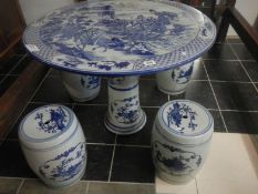 An Oriental table and 4 stools