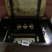 A Victorian 10 tune music box with 3 bells