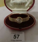A 9ct gold ladies Omega wristwatch with 9ct gold strap