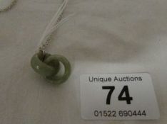 A jade pendant being 2 interlocking rings on chain