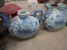 A pair of blue and white Oriental style teapots