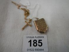 A 9ct gold cross with yellow metal chain and yellow metal locket