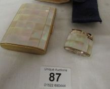 A Mother of pearl cigarette case and matching lighter