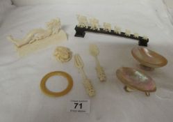 A mixed lot of bone and ivory carved items