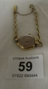 A 9ct gold ladies wristwatch with 9ct gold strap (Dennison)