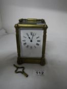 A brass carriage clock with key