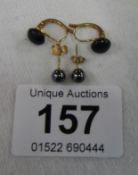 A pair of 18ct black stud earrings and 9ct black pearl earrings