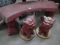 An Oriental garden bench and Dogs of foo figures