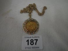 A George V Sovereign in 9ct gold mount with chain