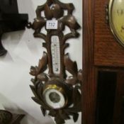 A carved wood barometer