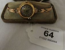 An 18ct gold watch head with 15ct gold strap