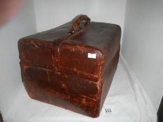 A vanity case with silver topped bottles, ivory backed brushes and fittings