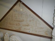 An early 20C framed bandage with pictures of first aid