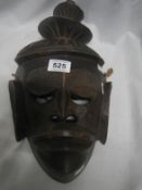 A tribal mask with 3 tier hair piece
