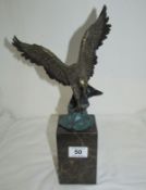 A cold painted bronze eagle signed Milo on marble plinth